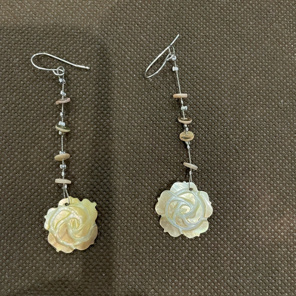 Carved, mother-of- pearl like flowers. Accented with tiny beads on the dangle.